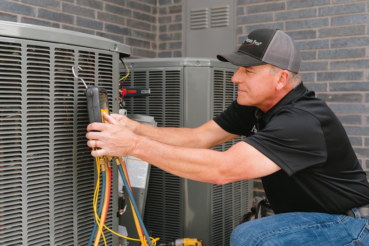 How do I know if my AC unit's refrigerant is low, and what does it cost to recharge it