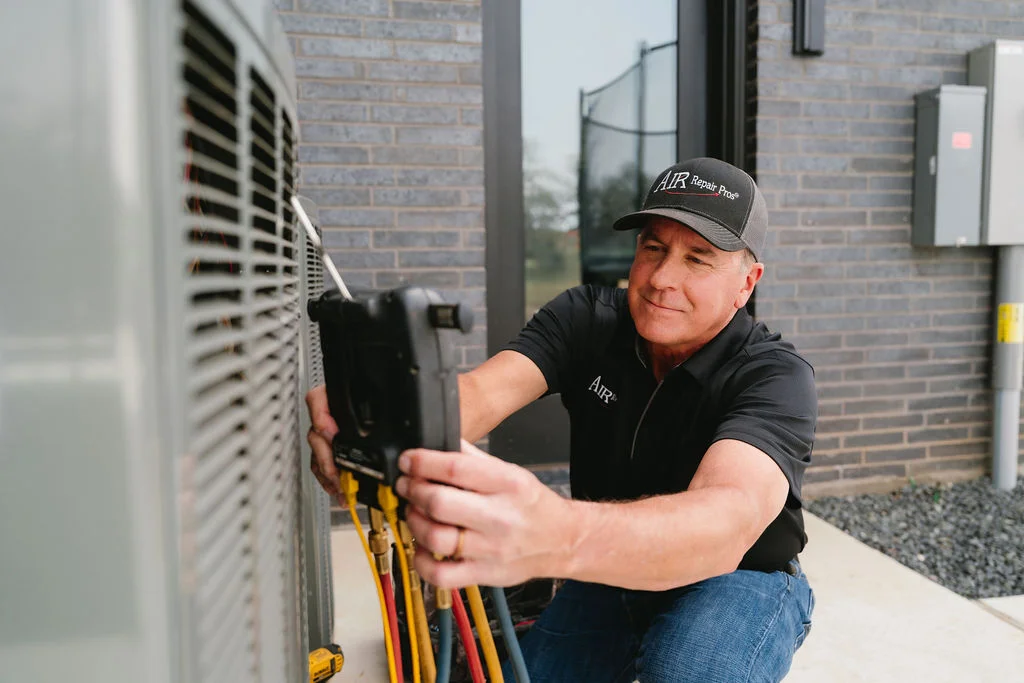 HVAC technician diagnosing a residential heat pump for short cycling and sizing issues